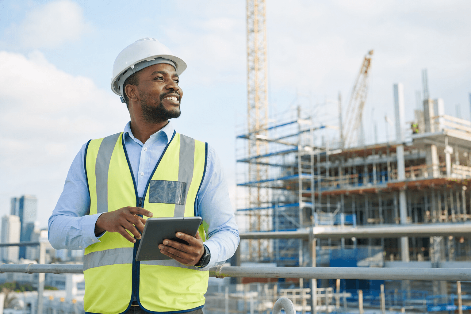 A confident construction project manager at a building site, protected by APA Contractors All Risks Insurance